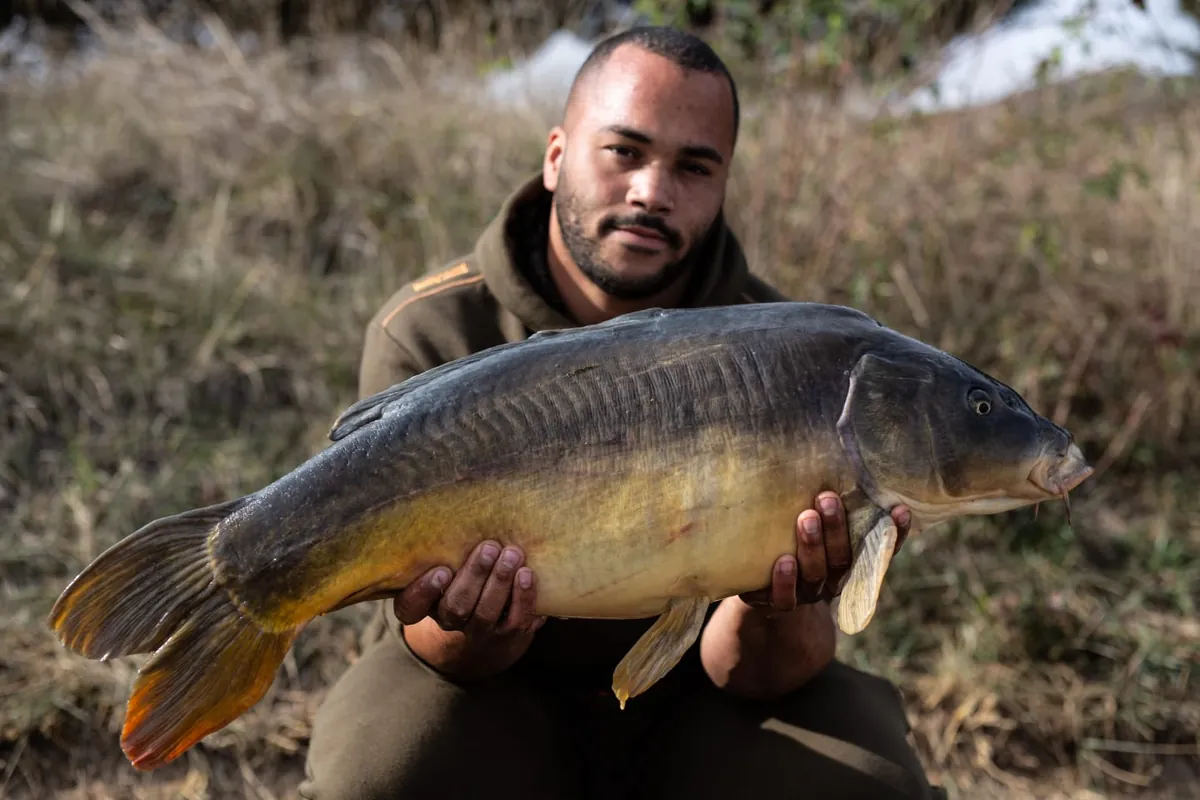 Jermaine holding a mirror carp