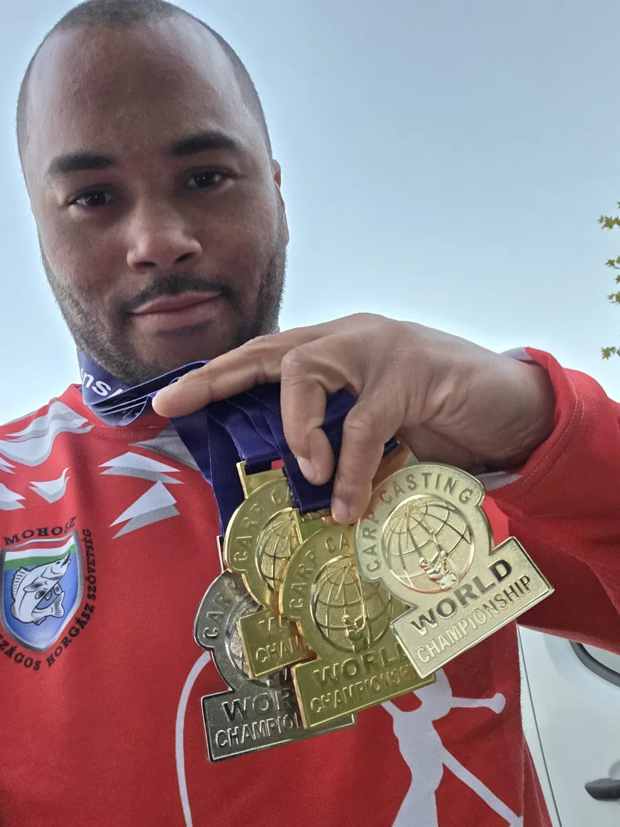 Jermaine holding a handful of World Carp Casting Championship gold medals